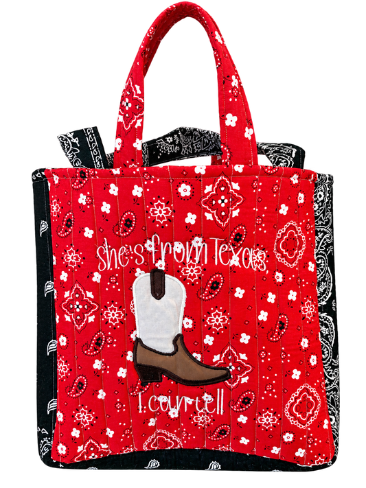 She's From Texas Sunset-size tote in red and black bandana fabric with cowboy boot appliqué and example name embroidery